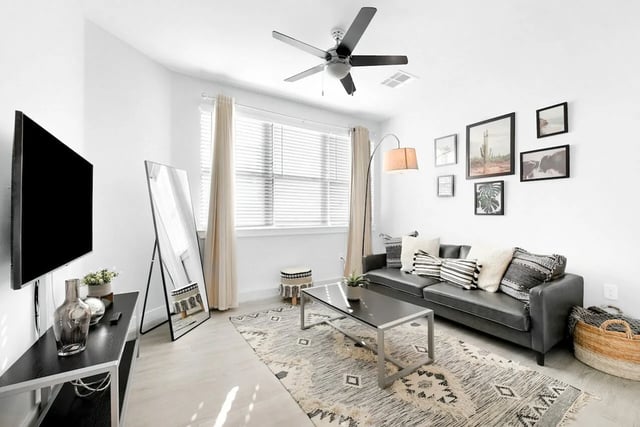 Sofa coffee table mirror and TV living room at Park Place Tampa in Tampa Student Accommodation