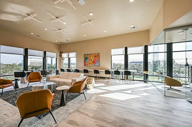 Sofa chairs coffee tables and bar stools living room at Park Place Tampa in Tampa Student Accommodation