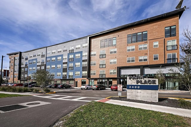 Modern apartment building with cars exterior at Park Place Tampa in Tampa Student Accommodation