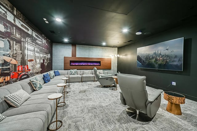 Sofa fireplace drum set large TV lounge area at Park Place Tampa in Tampa Student Accommodation