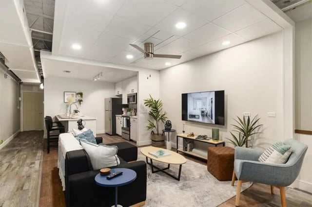 Sofa coffee table and kitchen area living room at Nine31 in Gainesville Student Accommodation