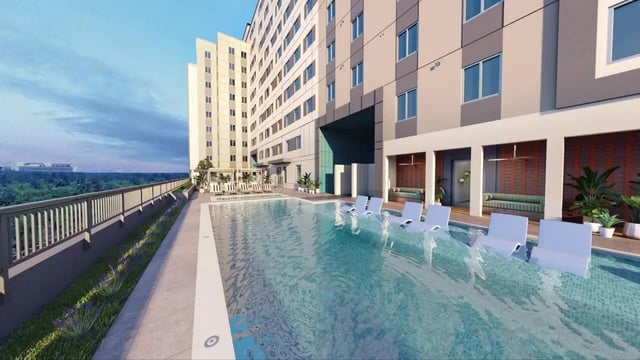 Pool with submerged chairs and lounge exterior at Nine31 in Gainesville Student Accommodation
