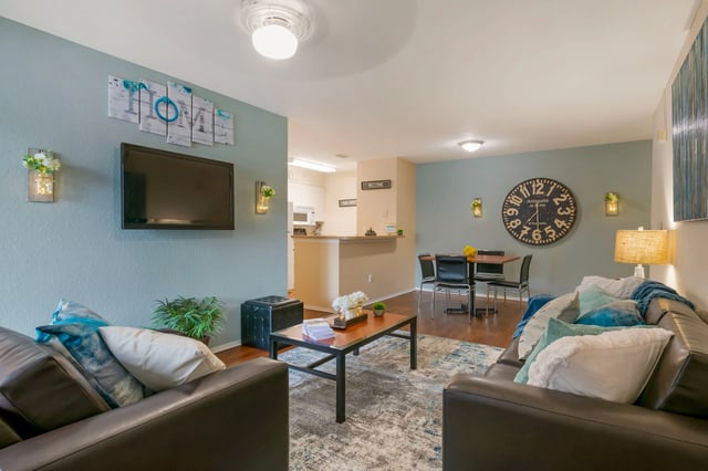Sofa coffee table rug and dining table living room at College Station Orlando in Orlando Student Accommodation