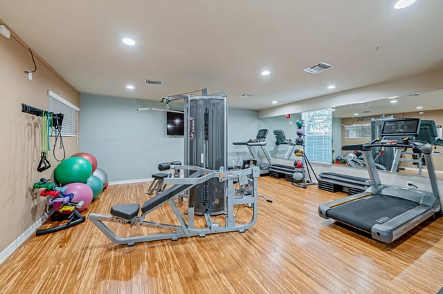 Gym equipment treadmills weight machine exercise balls gym at College Station Orlando in Orlando Student Accommodation