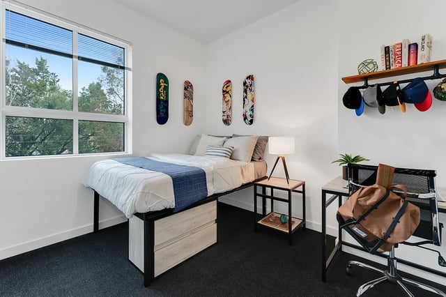 Bed desk and skateboards in student bedroom at Midtown Gainesville in Gainesville Student Accommodation