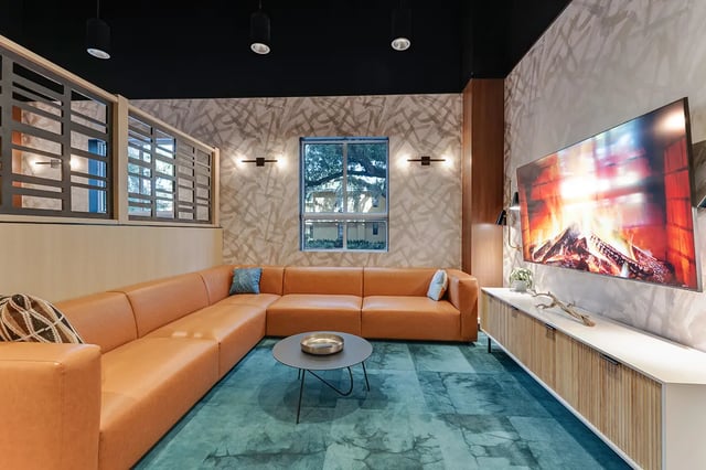 Large orange sectional couch with coffee table living room at Midtown Gainesville in Gainesville Student Accommodation