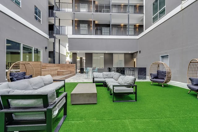 Sofa chairs coffee table bar and balcony exterior at Midtown Gainesville in Gainesville Student Accommodation