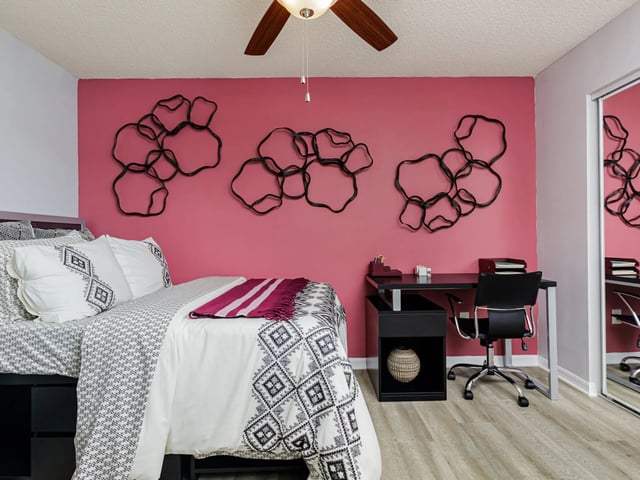 Bed desk chair and wall art bedroom at Reflections in Tampa Student Accommodation