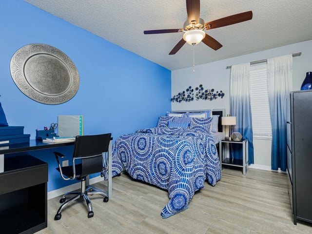Blue bed and desk study area bedroom at Reflections in Tampa Student Accommodation
