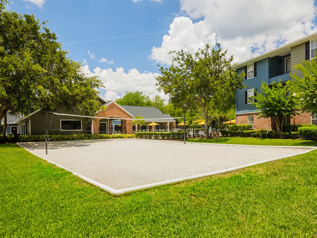 Volleyball court grass lawn and buildings exterior at Reflections in Tampa Student Accommodation