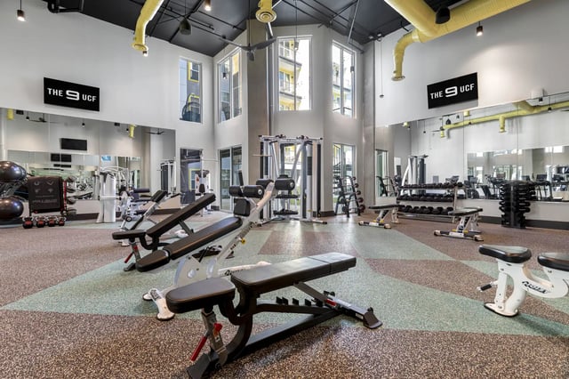 Weight benches dumbbells and exercise machines gym at The 9 UCF in Orlando Student Accommodation