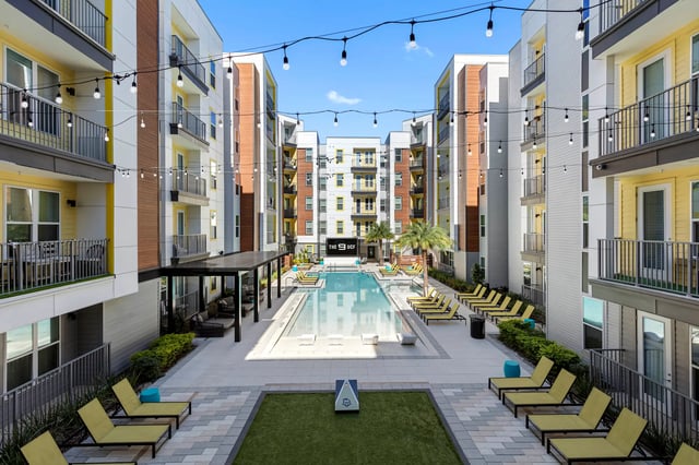 Apartment buildings pool lounge chairs exterior at The 9 UCF in Orlando Student Accommodation