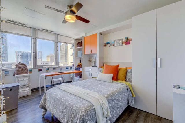 Bed desk storage closet and large windows bedroom at 220 Madison in Tampa Student Accommodation