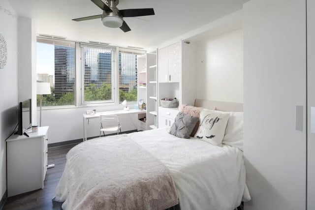 Bed desk television and window bedroom at 220 Madison in Tampa Student Accommodation