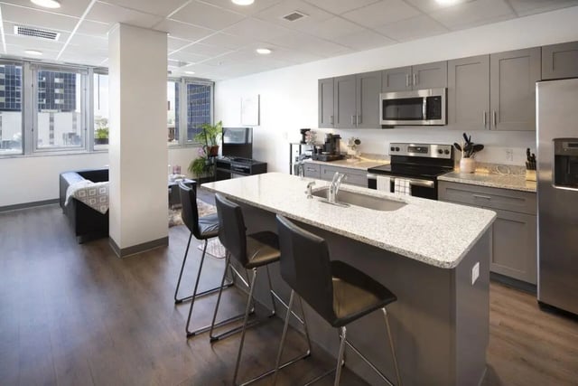 Modern kitchen with island and seating kitchen at 220 Madison in Tampa Student Accommodation
