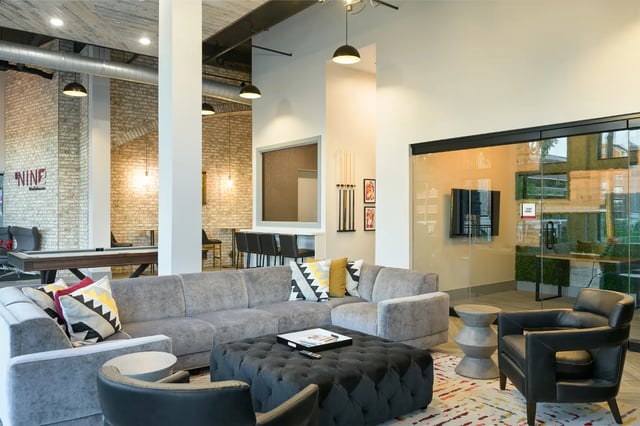 Sectional sofa tufted ottoman pool table living area at The Nine at Tallahassee in Tallahassee Student Accommodation