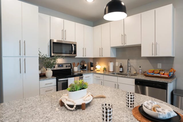 Modern kitchen with white cabinets stove and dishwasher Kitchen at The Nine at Tallahassee in Tallahassee Student Accommodation