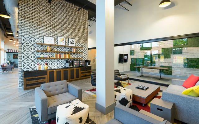 Modern lounge with couches coffee makers and bookshelves lounge at The Nine at Tallahassee in Tallahassee Student Accommodation