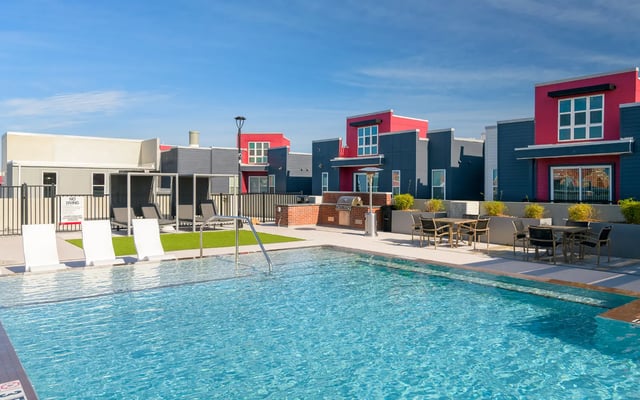 Pool lounge chairs grill seating area exterior at The Nine at Tallahassee in Tallahassee Student Accommodation