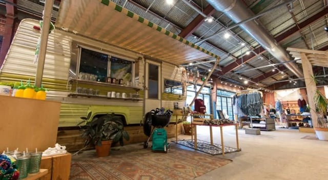 Camper trailer with awning grill and clothing retail space at FSU Collegetown in Tallahassee Student Accommodation
