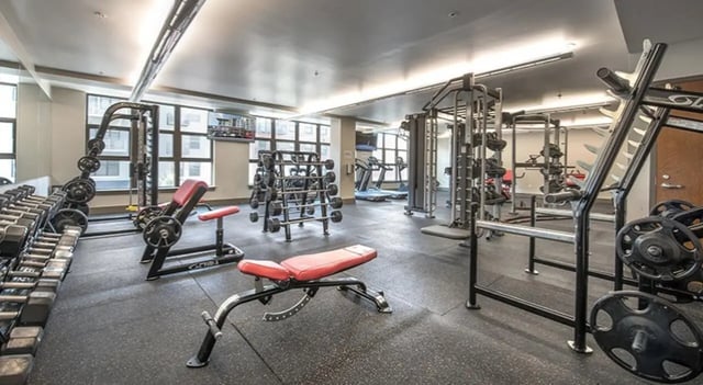 Dumbbells weight racks benches and treadmills fitness center at FSU Collegetown in Tallahassee Student Accommodation