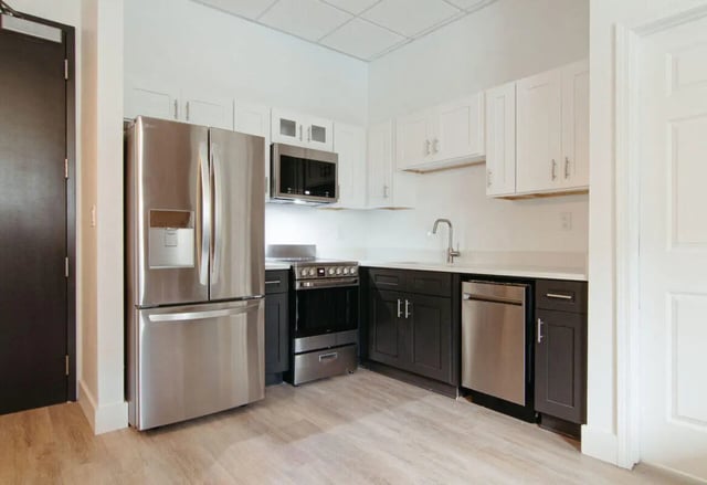 Stainless steel refrigerator oven sink dishwasher kitchen at CigarLofts in Tampa Student Accommodation