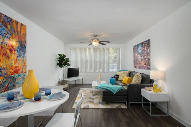 Dining table sectional sofa artwork living room at The Landings Gainesville in Gainesville Student Accommodation