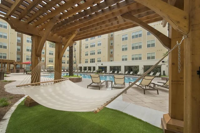 Hammock and lounge chairs by pool exterior at Saga Tallahassee in Tallahassee Student Accommodation