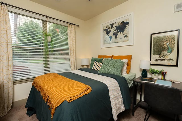 Bed desk pillows blanket map painting bedroom at Saga Tallahassee in Tallahassee Student Accommodation