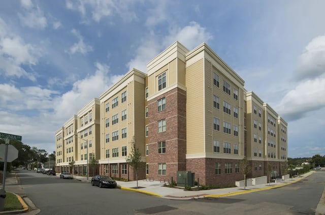 Modern tan and brick building on street exterior at Saga Tallahassee in Tallahassee Student Accommodation