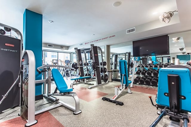 Gym equipment weight racks and television fitness center at Saga Tallahassee in Tallahassee Student Accommodation