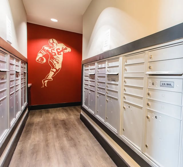 Mailboxes with football mural hallway interior at Saga Tallahassee in Tallahassee Student Accommodation