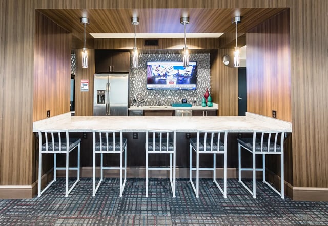 Bar with stools and TV area kitchen at Saga Tallahassee in Tallahassee Student Accommodation