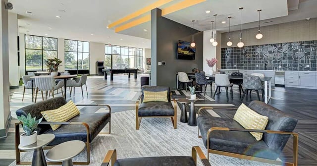 Chairs tables pool table lounge area living room at Continuum Apartments in Gainesville Student Accommodation