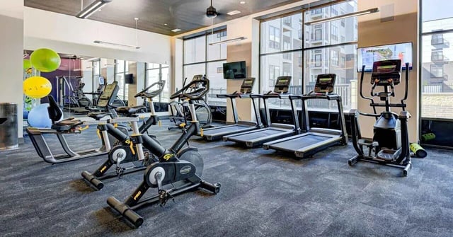 Gym with treadmills stationary bikes and elliptical gym at Continuum Apartments in Gainesville Student Accommodation