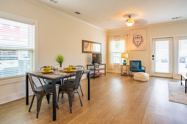 Dining table chairs TV mirror and seating living room at The Retreat at Tampa in Tampa Student Accommodation