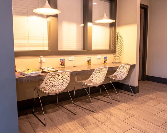 Three chairs at desk with magazines study area at The Retreat at Tampa in Tampa Student Accommodation