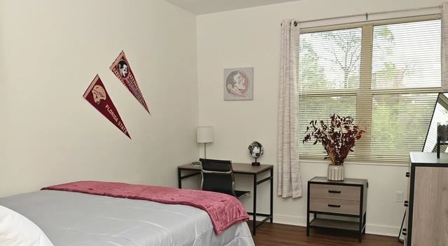Bed desk pennants and dresser bedroom at Burt Reynolds Hall in Tallahassee Student Accommodation
