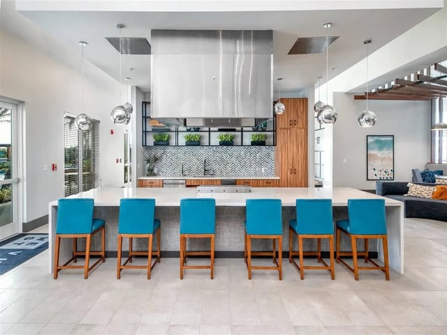 Bar stools and kitchen island in common area kitchen at Alvista West Vue in Orlando Student Accommodation