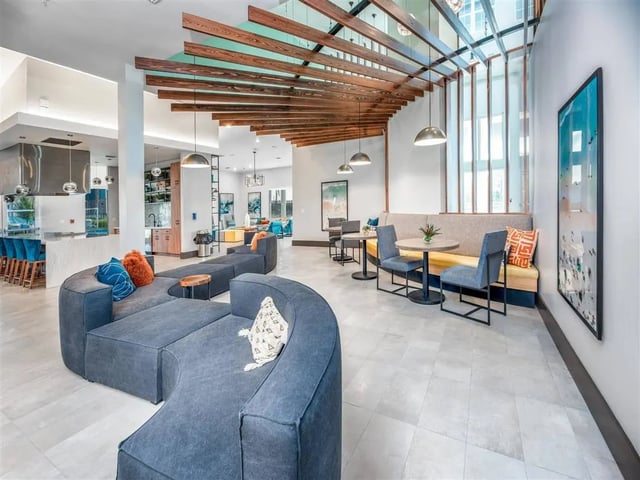 Spacious seating area with modern lounge furniture and kitchen lounge at Alvista West Vue in Orlando Student Accommodation