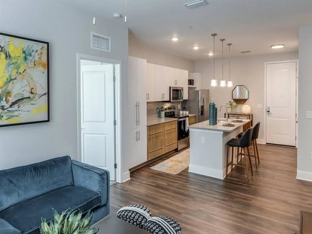 Blue sofa kitchen island modern living room at Alvista West Vue in Orlando Student Accommodation