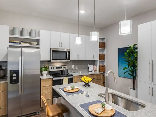 Modern kitchen with stainless steel appliances and island kitchen at Alvista West Vue in Orlando Student Accommodation