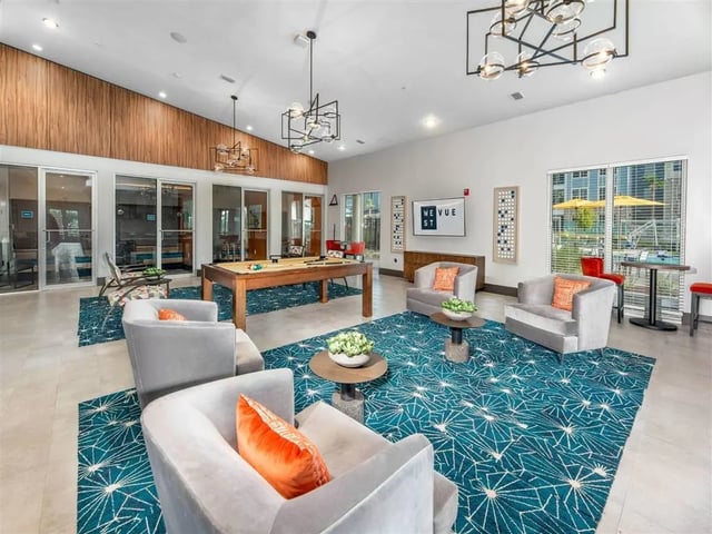 Pool table chairs and sectional seating living room at Alvista West Vue in Orlando Student Accommodation