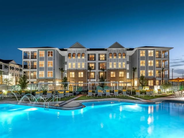 Apartment building with pool and lounge chairs exterior at Alvista West Vue in Orlando Student Accommodation