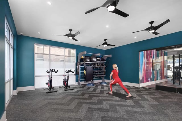 Fitness room with bikes and weights gym at Urban Enclave in Tallahassee Student Accommodation