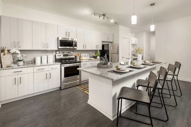 Modern kitchen with island and four stools kitchen at Urban Enclave in Tallahassee Student Accommodation