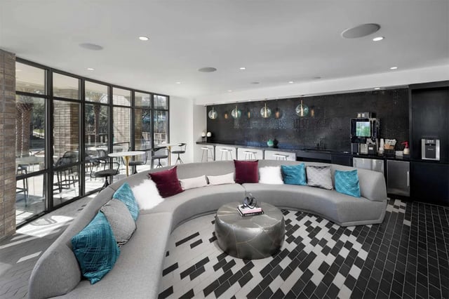 Curved sofa coffee table lounge area at Urban Enclave in Tallahassee Student Accommodation