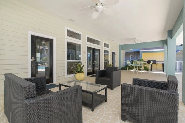 Wicker seating glass table outdoor dining grill patio at Museum Walk in Gainesville Student Accommodation