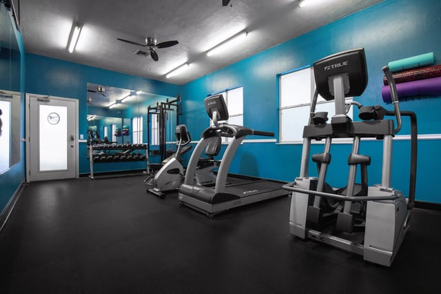 Gym equipment includes treadmills and weight rack Fitness center at Museum Walk in Gainesville Student Accommodation