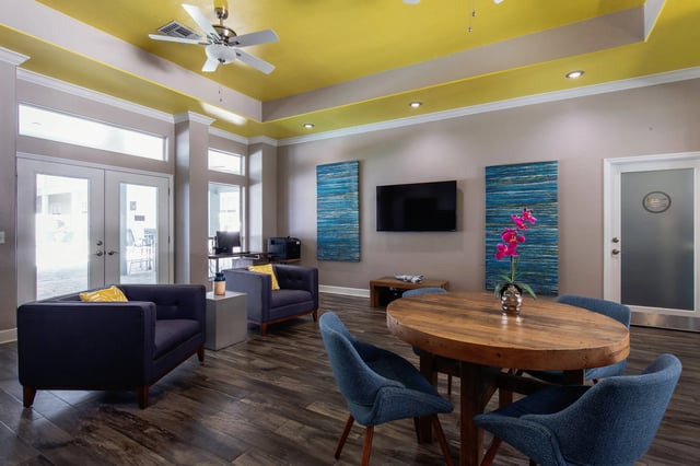 Modern lounge seating with TV and dining table Living room at Museum Walk in Gainesville Student Accommodation